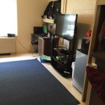 After college dorm room makeover, featuring desk, TV w/xBox, refrigerator and microwave