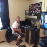 A happy college student, proud of his dorm room. Makeover a success!